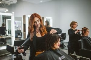 Kaeli Davis styles a client's hair.