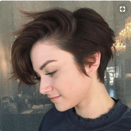 Girl with brunette pixie cut.