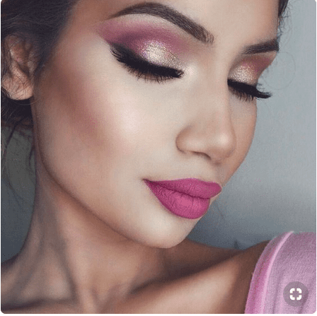 Brunette girl with pink eye makeup and lipstick.